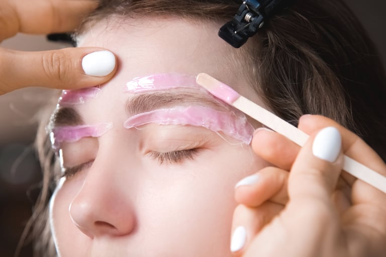 Professional beauty worker performing waxing procedure